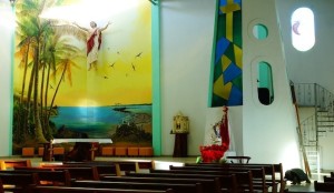 inside Catholic church local art palm trees tortoise stained glass bluefooted booby frigatebird