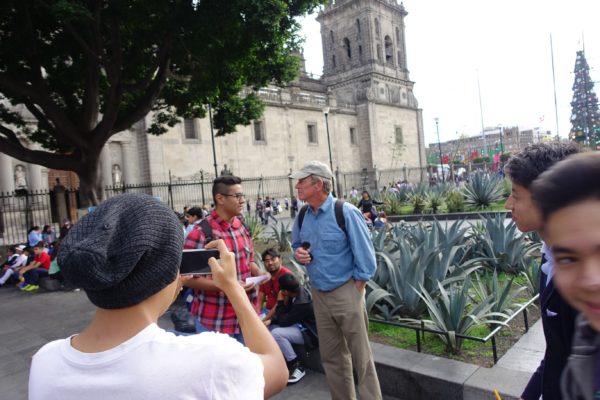 Doug helps a srudent from the Politecnico with his homework. Students sought us out several times, and filmed each other on their phones asking us questions like What is your favorite Mexican food' and What is your father’s name. How do you suppose they recognized us as tourists?
